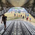 Walking down the ramp of an National Guard cargo plane